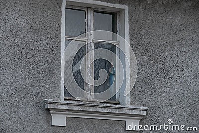 Virgin Mary figurine in an old, dusty window. Stock Photo