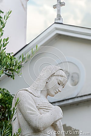 Virgin Mary statue in front of the Church of the Assumption of the Blessed Virgin Mary Editorial Stock Photo