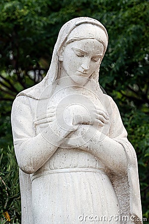 Virgin Mary statue in front of the Church of the Assumption of the Blessed Virgin Mary Editorial Stock Photo