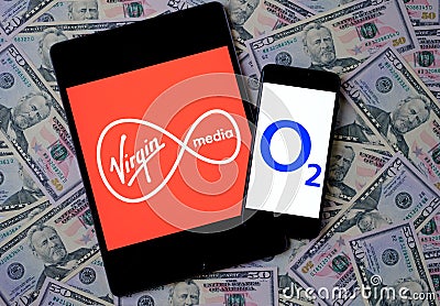 Virgin Media and O2 Telefonica logos on the mobile devices placed on dollars. Concept for potential multibillion merger of the two Editorial Stock Photo