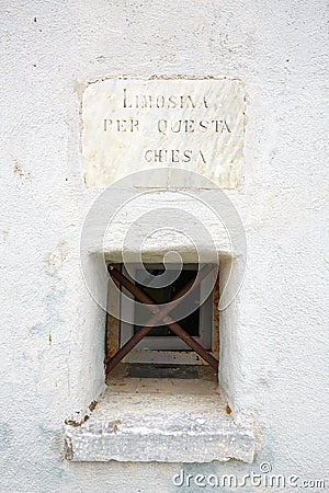 Virgin of the Snow ancient church on mountain top, small window for charity in Prato Nevoso, Italy Editorial Stock Photo