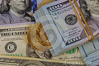 Virtual cryptocurrency money Bitcoin golden coin on United States US dollar bill Stock Photo