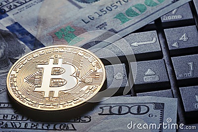 Virtual currency bitcoin against the background of dollars and c Editorial Stock Photo