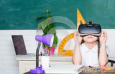 Virtual education. Child cute pupil wear hmd vr glasses. Studying in virtual reality. Modern technology. Interesting Stock Photo