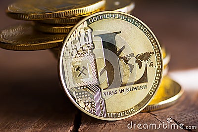 Virtual money Litecoin cryptocurrency - pile of coins and gold LTC coin on the wooden background Stock Photo
