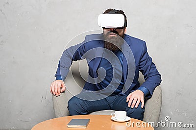 Virtual office and work space. Businessman sit chair wear hmd explore virtual reality or ar. Business partner interact Stock Photo