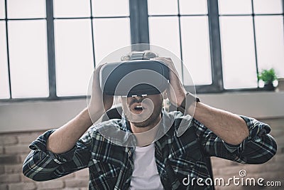 Exited man using a new VR headset Stock Photo