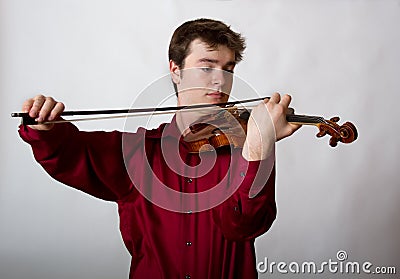 Virtuoso Teen Male Violinist in red Stock Photo