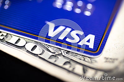 Visa card on top of a dollar bill Editorial Stock Photo