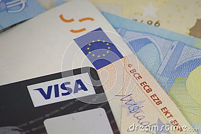 Visa credit card on top of Euro bank notes Editorial Stock Photo