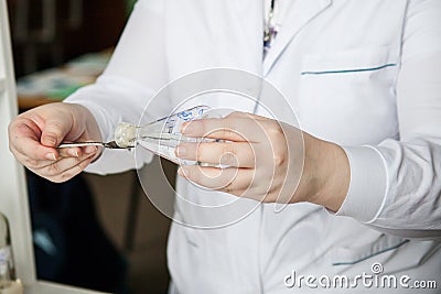 Viscous transparent substance on the fingers of a chemist in the laboratory Stock Photo