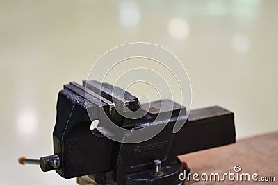 Vise on workbench. Vise tool on wooden top surface. Tool for metalworking. Engineer or blacksmith and industry Stock Photo