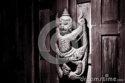 Vishnu garuda statue on wooden wall Stock Photo