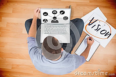 Vision against young creative businessman working on laptop Stock Photo