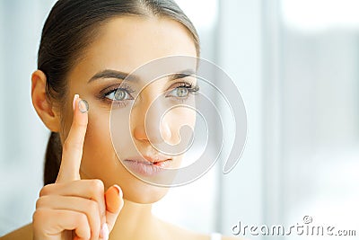 Vision Contact Lenses. Closeup With Beautiful Woman Face Stock Photo