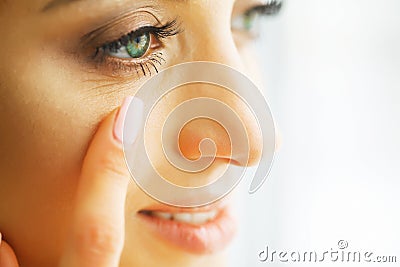 Vision Contact Lenses. Closeup With Beautiful Woman Face Stock Photo