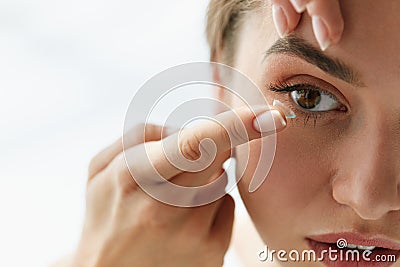 Vision Contact Lenses. Closeup With Beautiful Woman Face Stock Photo