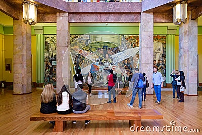 Visitors admiring the murals by Diego Rivera at the Palacio de Bellas Artes in Mexico City Editorial Stock Photo