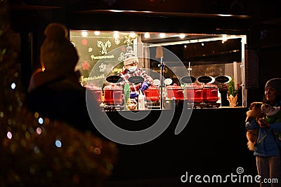 Local Kyivans and tourists visit the public space of the Roshen Chocolate Factory decorated with Christmas lights in Kyiv, Ukraine Editorial Stock Photo