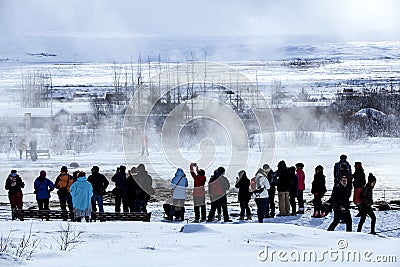 Visitors watching the eruption of a geyser in Iceland Editorial Stock Photo