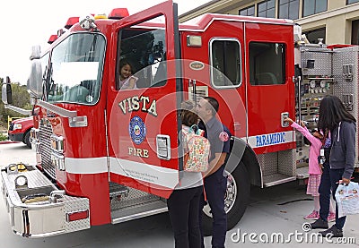 Vista, CA / USA - October 13, 2018: People interact with firefighters and explore trucks during fire prevention month open house. Editorial Stock Photo