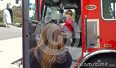 Vista, CA / USA - October 13, 2018: People interact with firefighters and explore trucks during fire prevention month open house. Editorial Stock Photo