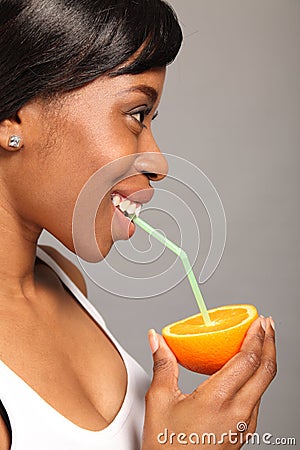 Vitamin C orange fruit drink for black woman Stock Photo