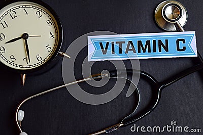 Vitamin C on the paper with Healthcare Concept Inspiration. alarm clock, Black stethoscope. Stock Photo