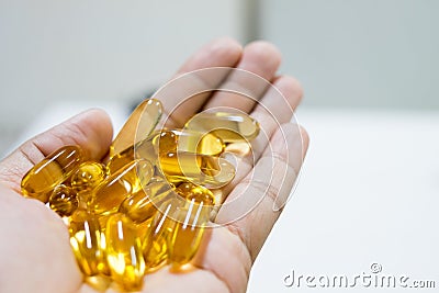 Vitamin Capsules Omega pills on hand, Health care concept, Stock Photo