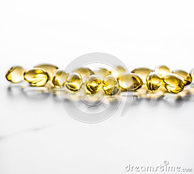 Vitamin D and golden Omega 3 pills for healthy diet nutrition, fish oil food supplement pill capsules, healthcare and medicine as Stock Photo