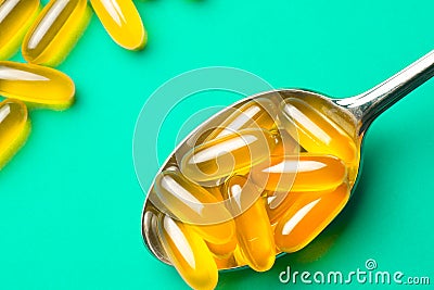 Vitamin e. Fish oil capsules on blue background. Copy space for Stock Photo