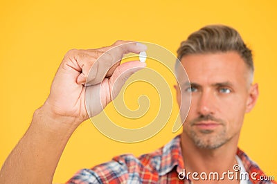 Vitamin pill in hand. Side effects. Medicines concept. Hemp derived CBD. Food additives vitamins for male health Stock Photo
