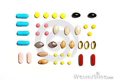 Vitamins, dietary supplements in a row , Background from multi-colored tablets Stock Photo