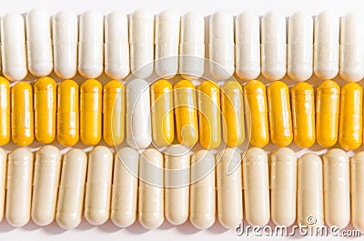 Colorful vitamins in capsules lying in a row Stock Photo