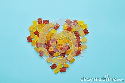 Vitamins gummy bears on blue background. Stock Photo