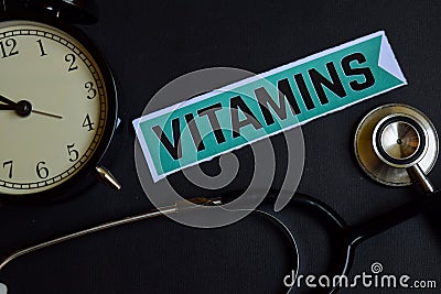 Vitamins on the print paper with Healthcare Concept Inspiration. alarm clock, Black stethoscope. Stock Photo