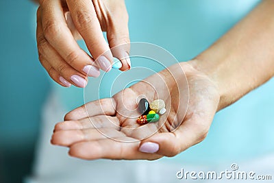 Vitamins And Supplements. Female Hand Holding Colorful Pills Stock Photo