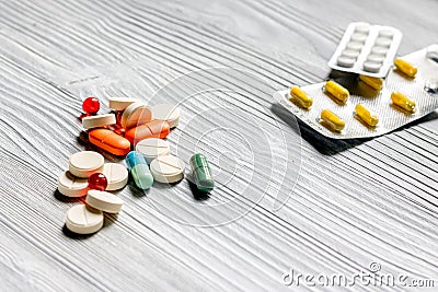 Vitamins and supplements. Pills and pill bottle on grey wooden table background copyspace Stock Photo