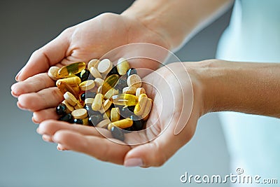 Vitamins And Supplements. Woman Hands Full Of Medication Pills Stock Photo