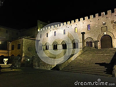 Viterbo, medieval ancient city near Rome, Italy. Papal Palace, square, staircase, night, shadows and light Stock Photo