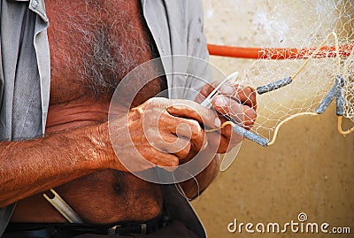 Fisherman Fixing Net Stock Photo