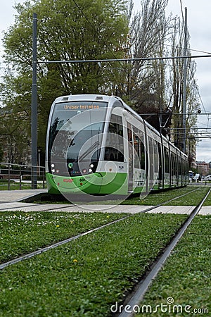 Electric tram circulating on tracks covered with grass through the city of Vitoria, Pais Vasco, Editorial Stock Photo