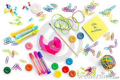 Vive la rentree meaning back to school in French written on sticky notes among colorful school supplies isolated on white Stock Photo