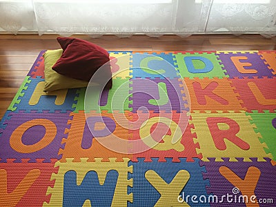 Vivid color baby playmat with two small pillows in the living room Stock Photo