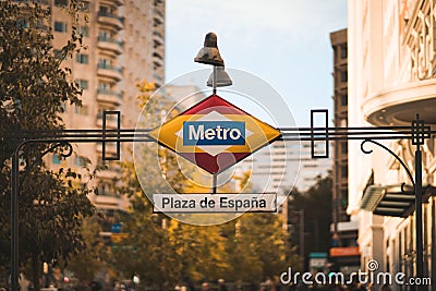 Vivid color image of a city street featuring a hanging metro sign Editorial Stock Photo