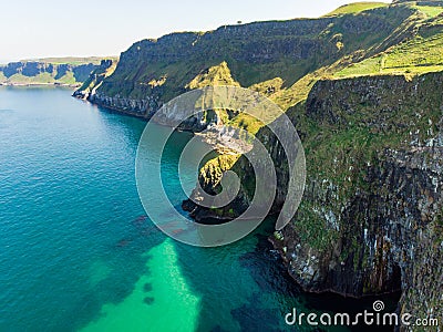 Vivid emerald-green water at Ballintoy harbour along the Causeway Coast in County Antrim Stock Photo