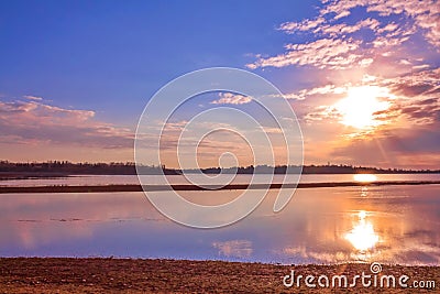 Glowing Sunrise Sky Reflecting In A Park Lake Stock Photo