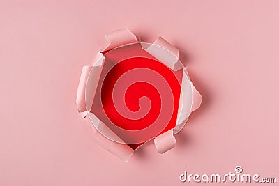 Vivid pink torn paper with burst hole background. Minimal abstract concept Stock Photo