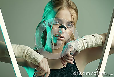 Strong beautiful girl with blonde hair, confident look, fists in protective boxing bandages Stock Photo