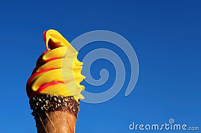Vivid Yellow Banana with Raspberry Soft Serve Ice Cream Cone Against Sunny Blue Sky Stock Photo